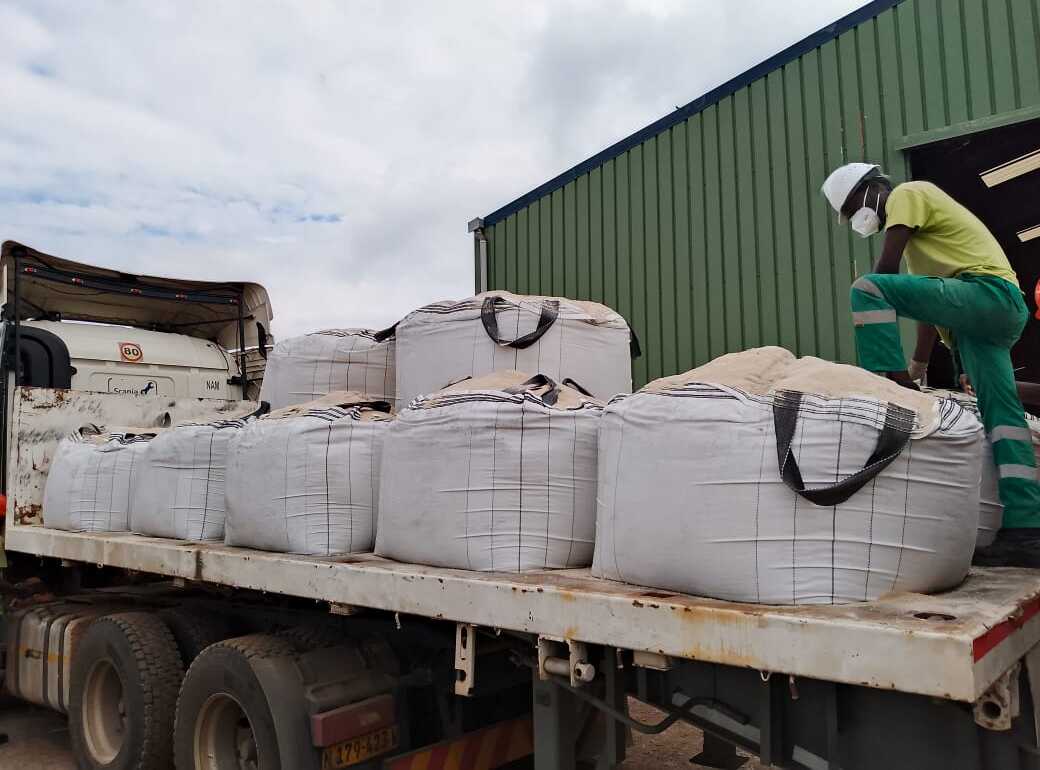 Loading bulk bags of calcium carbonate onto a flatbed truck