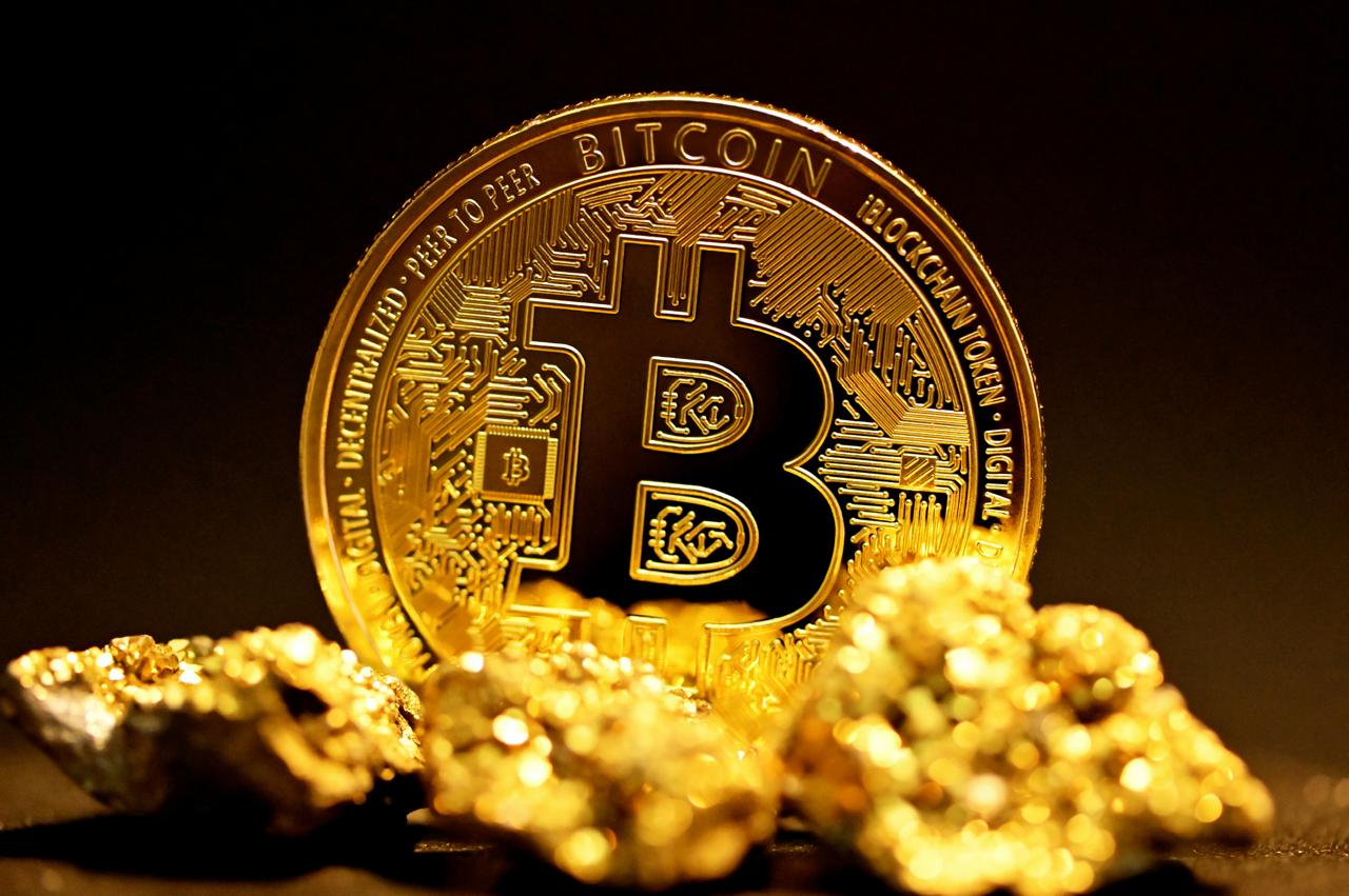 Bitcoin coin resting among raw gold nuggets
