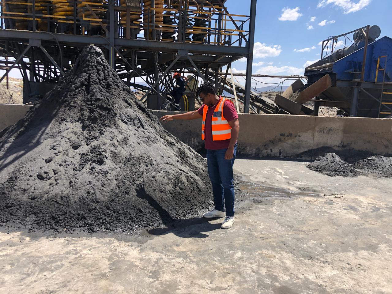 Inspecting mineral concentrate beside the spiral concentrator plant