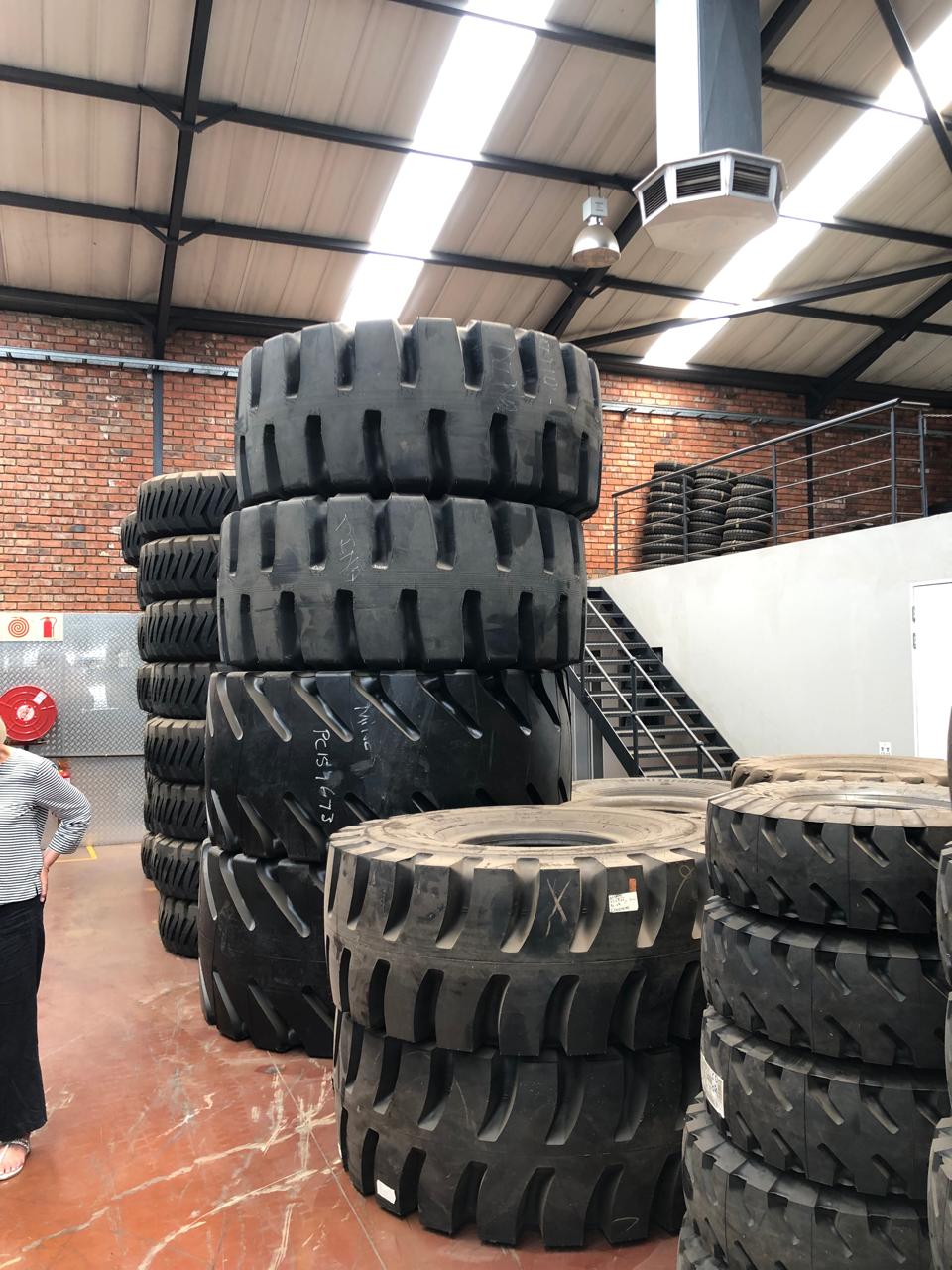 Stacked mining tyre stock inside the warehouse